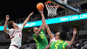 Dec 21, 2024; San Jose, California, USA; Oregon Ducks forward Kwame Evans Jr. (10) shoots against Stanford Cardinal guard Oziyah Sellers (4) and guard Ryan Agarwal (obscured right) during the second half at SAP Center at San Jose.