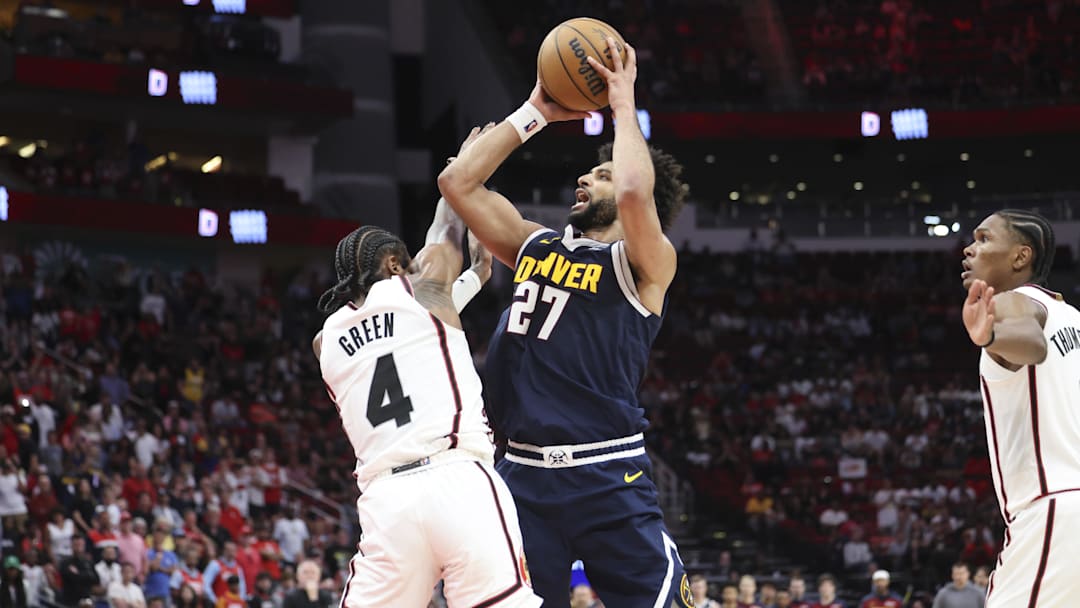 Mar 23, 2025; Houston, Texas, USA; Denver Nuggets guard Jamal Murray (27) attempts to shoot the ball as Houston Rockets guard Jalen Green (4) defends during the fourth quarter at Toyota Center. Mandatory Credit: Troy Taormina-Imagn Images