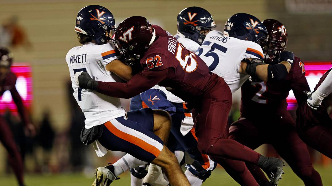 Nov 30, 2024; Blacksburg, Virginia, USA; Virginia Tech Hokies defensive lineman Antwaun Powell-Ryland (52) sacks Virginia Cavaliers quarterback Tony Muskett (7) during the first quarter at Lane Stadium. Mandatory Credit: Peter Casey-Imagn Images