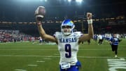 Dec 26, 2023; Phoenix, AZ, USA; Kansas Jayhawks quarterback Jason Bean (9) celebrates after defeating the UNLV Rebels at Chase Field. Mandatory Credit: Joe Camporeale-USA TODAY Sports