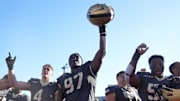 Army defensive lineman Dre Miller (97) and wide receiver Liam Fortner (4) celebrate after a game this season.