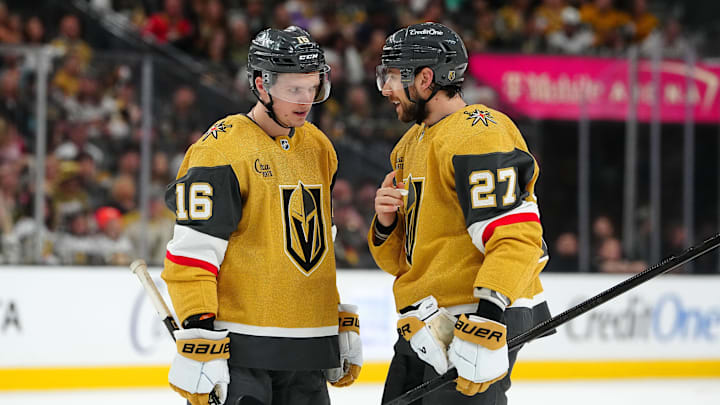 Apr 12, 2025; Las Vegas, Nevada, USA; Vegas Golden Knights left wing Pavel Dorofeyev (16) talks with Vegas Golden Knights defenseman Shea Theodore (27) before a face off against the Nashville Predators during the first period at T-Mobile Arena. Mandatory Credit: Stephen R. Sylvanie-Imagn Images