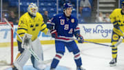 Aug 2, 2024; Plymouth, MI, USA; USA’s forward Teddy Stiga (9) sets up in front of Sweden's goaltender Melker Thelin (35) during the third period of the 2024 World Junior Summer Showcase at USA Hockey Arena. Mandatory Credit: David Reginek-Imagn Images