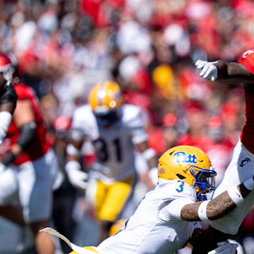 Cincinnati Bearcats running back Corey Kiner (21) breaks a tackle attempt by Pittsburgh Panthers defensive back Donovan McMillon (3) in the third quarter of the College Football game at Nippert Stadium in Cincinnati on Saturday, Sept. 7, 2024.