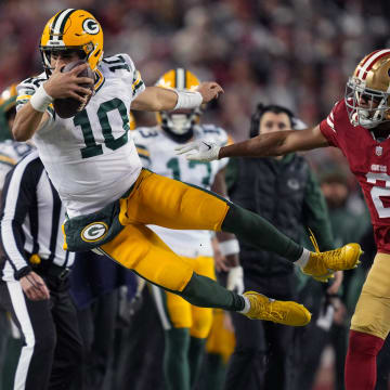 January 20, 2024; Santa Clara, CA, USA; San Francisco 49ers cornerback Deommodore Lenoir (2) pushes Green Bay Packers quarterback Jordan Love (10) out of bounds during the second quarter in a 2024 NFC divisional round game at Levi's Stadium. Mandatory Credit: Kyle Terada-USA TODAY Sports