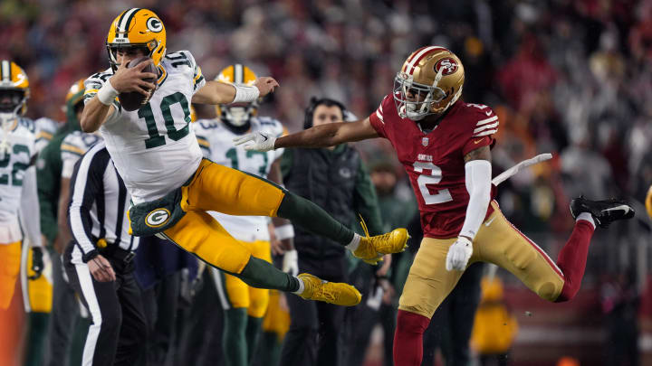 January 20, 2024; Santa Clara, CA, USA; San Francisco 49ers cornerback Deommodore Lenoir (2) pushes Green Bay Packers quarterback Jordan Love (10) out of bounds during the second quarter in a 2024 NFC divisional round game at Levi's Stadium. Mandatory Credit: Kyle Terada-USA TODAY Sports