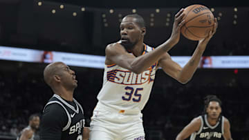 Feb 20, 2025; Austin, Texas, USA; Phoenix Suns forward Kevin Durant (35) looks to drive to the basket while defended by San Antonio Spurs guard Chris Paul (3) during the first half at Moody Center. Mandatory Credit: Scott Wachter-Imagn Images