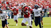 Sep 6, 2025; Raleigh, North Carolina, USA; North Carolina State Wolfpack quarterback CJ Bailey (11) runs with the football to make a touchdown during the first half of the game against Virginia Cavaliers at Carter-Finley Stadium. Mandatory Credit: Jaylynn Nash-Imagn Images