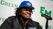 Fort Myers Green Wave defensive lineman Kendall Guervil commits to the University of Florida while surrounded by friends and family during a ceremony at Fort Myers High School in Fort Myers, Fla., on Wednesday, July 2, 2025.