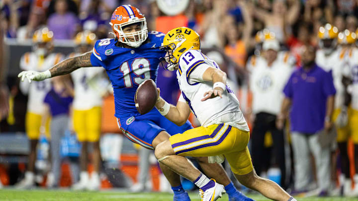 Nov 16, 2024; Gainesville, Florida, USA; Florida Gators defensive end T.J. Searcy (19) chases LSU Tigers quarterback Garrett Nussmeier (13) during the second half at Ben Hill Griffin Stadium. Mandatory Credit: Matt Pendleton-Imagn Images