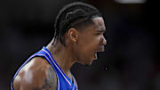 Jan 11, 2025; Cincinnati, Ohio, USA; Kansas Jayhawks guard Shakeel Moore (0) yells after dunking the ball against the Cincinnati Bearcats in the second half at Fifth Third Arena. Mandatory Credit: Aaron Doster-Imagn Images