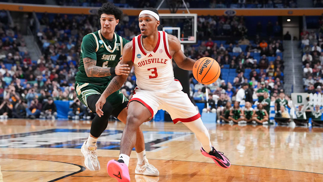 Mar 19, 2026; Buffalo, NY, USA; Louisville Cardinals guard Ryan Conwell (3) drives to the basket against South Florida Bulls guard Wes Enis (2) during the second half during a first round game of the men's 2026 NCAA Tournament at Keybank Center. Mandatory Credit: Gregory Fisher-Imagn Images