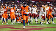 Nov 30, 2025; Landover, Maryland, USA; Denver Broncos running back RJ Harvey (12) celebrates after scoring a touchdown against the Washington Commanders in overtime of the game at Northwest Stadium. Mandatory Credit: Peter Casey-Imagn Images