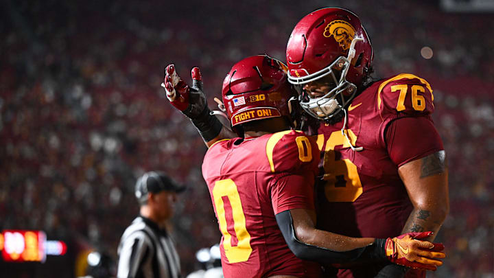 USC Trojans running back Quinten Joyner (0) celebrates with offensive lineman Mason Murphy (76) after scoring a touchdown.