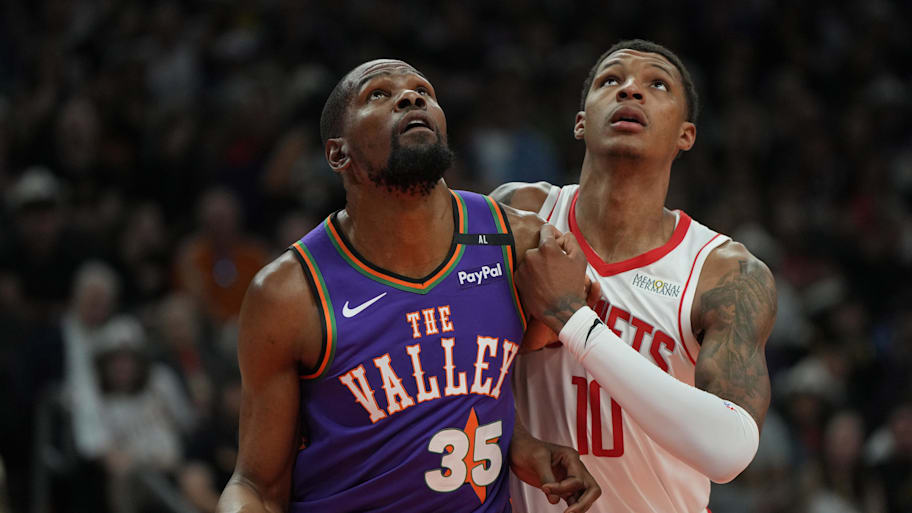 Kevin Durant battles Jabari Smith Jr. for a rebound during a March game. | Rick Scuteri-Imagn Images