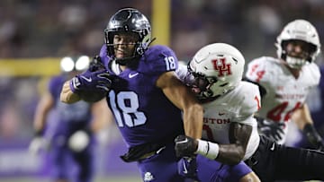 Oct 4, 2024; Fort Worth, Texas, USA; TCU Horned Frogs wide receiver Jack Bech (18) breaks the tackle of Houston Cougars defensive back Latrell McCutchin Sr. (1) and scores a touchdown in the fourth quarter at Amon G. Carter Stadium. Mandatory Credit: Tim Heitman-Imagn Images