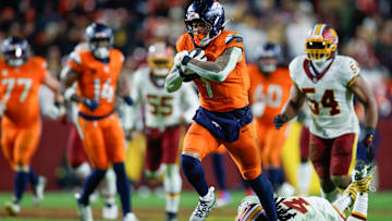 Nov 30, 2025; Landover, Maryland, USA; Denver Broncos tight end Evan Engram (1) avoids a tackle by Washington Commanders linebacker Frankie Luvu (4) in overtime of the game at Northwest Stadium. Mandatory Credit: Peter Casey-Imagn Images