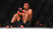 Feb 22, 2025; Seattle, Washington, USA; Henry Cejudo (red gloves) sits down after being poked in the eye by Song Yadong (blue gloves) in the bantamweight bout during UFC Fight Night at Climate Pledge Arena. Mandatory Credit: Steven Bisig-Imagn Images