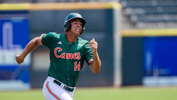 May 23, 2024; Charlotte, NC, USA; Miami (Fl) Hurricanes infielder Daniel Cuvet (14) runs home in the first inning against the Clemson Tigers during the ACC Baseball Tournament at Truist Field. Mandatory Credit: Scott Kinser-Imagn Images