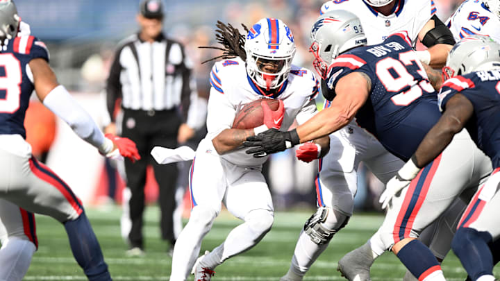 Oct 22, 2023; Foxborough, Massachusetts, USA; Buffalo Bills running back James Cook (4) runs against New England Patriots defensive end Lawrence Guy Sr. (93) during the first half at Gillette Stadium. Mandatory Credit: Brian Fluharty-Imagn Images