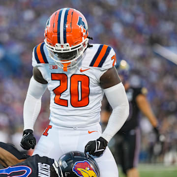 Sep 8, 2023; Lawrence, Kansas, USA; Illinois Fighting Illini defensive back Tyler Strain (20) celebrates after tackling Kansas Jayhawks wide receiver Quentin Skinner (0) during the first half at David Booth Kansas Memorial Stadium. Mandatory Credit: Jay Biggerstaff-Imagn Images