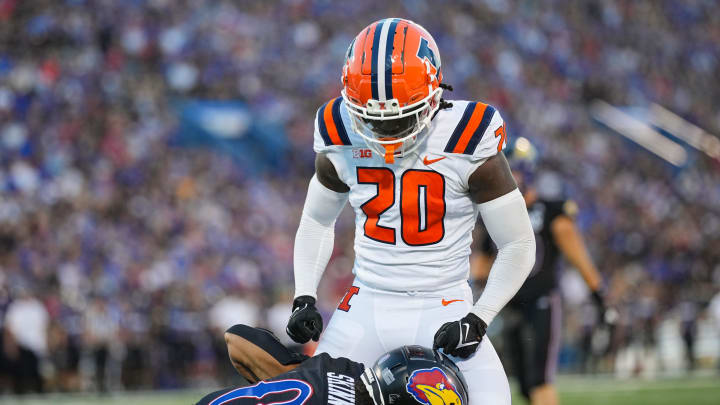 Sep 8, 2023; Lawrence, Kansas, USA; Illinois Fighting Illini defensive back Tyler Strain (20) celebrates after tackling Kansas Jayhawks wide receiver Quentin Skinner (0) during the first half at David Booth Kansas Memorial Stadium. Mandatory Credit: Jay Biggerstaff-USA TODAY Sports