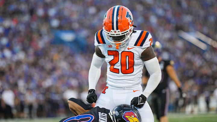 Sep 8, 2023; Lawrence, Kansas, USA; Illinois Fighting Illini defensive back Tyler Strain (20) celebrates after tackling Kansas Jayhawks wide receiver Quentin Skinner (0) during the first half at David Booth Kansas Memorial Stadium. Mandatory Credit: Jay Biggerstaff-Imagn Images