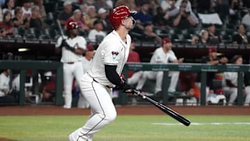 Sep 11, 2024; Phoenix, Arizona, USA; Arizona Diamondbacks outfielder Randal Grichuk (15) hits a two-run home run and 200th of his career against the Texas Rangers in the first inning at Chase Field. Mandatory Credit: Rick Scuteri-Imagn Images