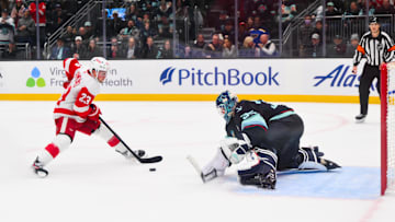 Kraken goaltender Joey Daccord defends against Red Wings left wing Lucas Raymond during a shootout.