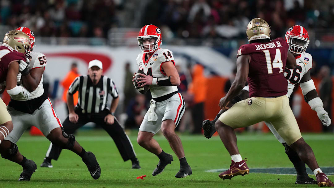 Dec 30, 2023; Miami Gardens, FL, USA; Georgia Bulldogs quarterback Gunner Stockton (14) drops back to passFlorida State Seminoles during the second half in the 2023 Orange Bowl at Hard Rock Stadium. Mandatory Credit: Jasen Vinlove-Imagn Images