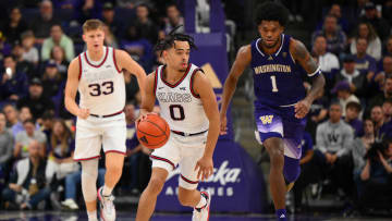 Dec 9, 2023; Seattle, Washington, USA; Gonzaga Bulldogs guard Ryan Nembhard (0) dribbles the ball while chased by Washington Huskies forward Keion Brooks Jr. (1) during the game at Alaska Airlines Arena at Hec Edmundson Pavilion. Mandatory Credit: Steven Bisig-USA TODAY Sports