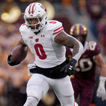 Wisconsin running back Braelon Allen (0) runs for a first down during the second quarter of their game Saturday, November 25, 2023 at Huntington Bank Stadium in Minneapolis, Minnesota. Wisconsin beat Minnesota 28-14.