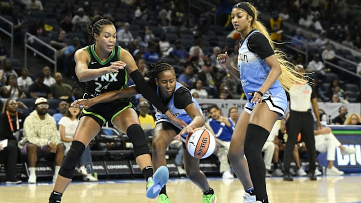 Jul 14, 2025; Chicago, Illinois, USA;  Chicago Sky guard Ariel Atkins (7) grabs the ball from Minnesota Lynx forward Napheesa Collier (24) as forward Angel Reese (5) looks on during the first half at Wintrust Arena. Mandatory Credit: Matt Marton-Imagn Images