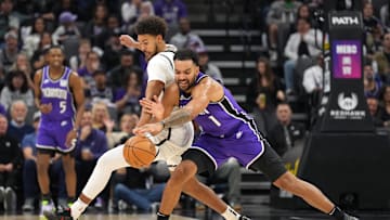 Nov 24, 2024; Sacramento, California, USA; Brooklyn Nets forward Cameron Johnson (left) and Sacramento Kings forward Trey Lyles (41) battle for the ball during the second quarter at Golden 1 Center. Mandatory Credit: Darren Yamashita-Imagn Images