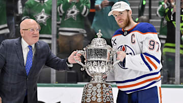 NHL deputy commissioner Bill Daly and Edmonton Oilers center Connor McDavid (97) pose with the trophy after winning the Western Conference Final