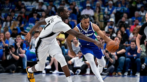 Apr 9, 2023; Dallas, Texas, USA; Dallas Mavericks guard A.J. Lawson (9) brings the ball up court past San Antonio Spurs cente