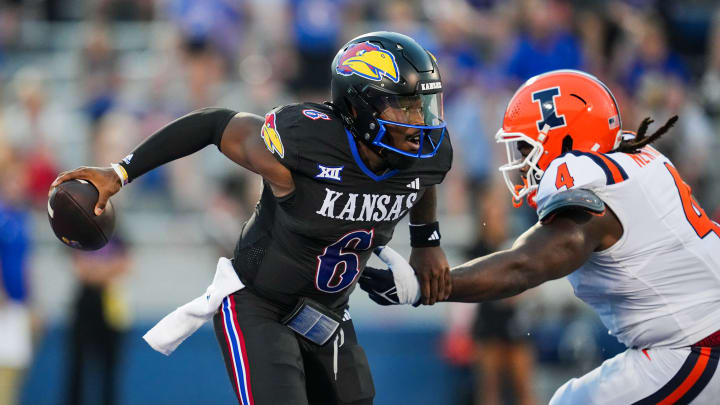 Sep 8, 2023; Lawrence, Kansas, USA; Kansas Jayhawks quarterback Jalon Daniels (6) against Illinois Fighting Illini defensive lineman Jer'Zhan Newton (4) during the first half at David Booth Kansas Memorial Stadium. Mandatory Credit: Jay Biggerstaff-USA TODAY Sports