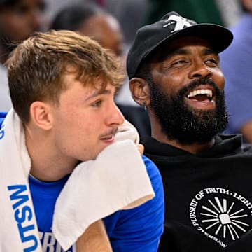 Oct 6, 2025; Fort Worth, Texas, USA; Dallas Mavericks forward Cooper Flagg (left) and guard Kyrie Irving (right) look on during the game between the Dallas Mavericks and the Oklahoma City Thunder at Dickie's Arena. Mandatory Credit: Jerome Miron-Imagn Images