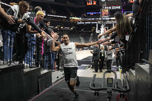 San Antonio Spurs guard Devin Vassell (24) greets fans after leaving the court before a game against the New Orleans Pelicans