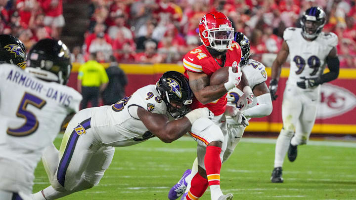 Sep 5, 2024; Kansas City, Missouri, USA; Kansas City Chiefs running back Samaje Perine (34) runs the ball as Baltimore Ravens defensive tackle Travis Jones (98) makes the tackle during the second half at GEHA Field at Arrowhead Stadium. Mandatory Credit: Denny Medley-Imagn Images