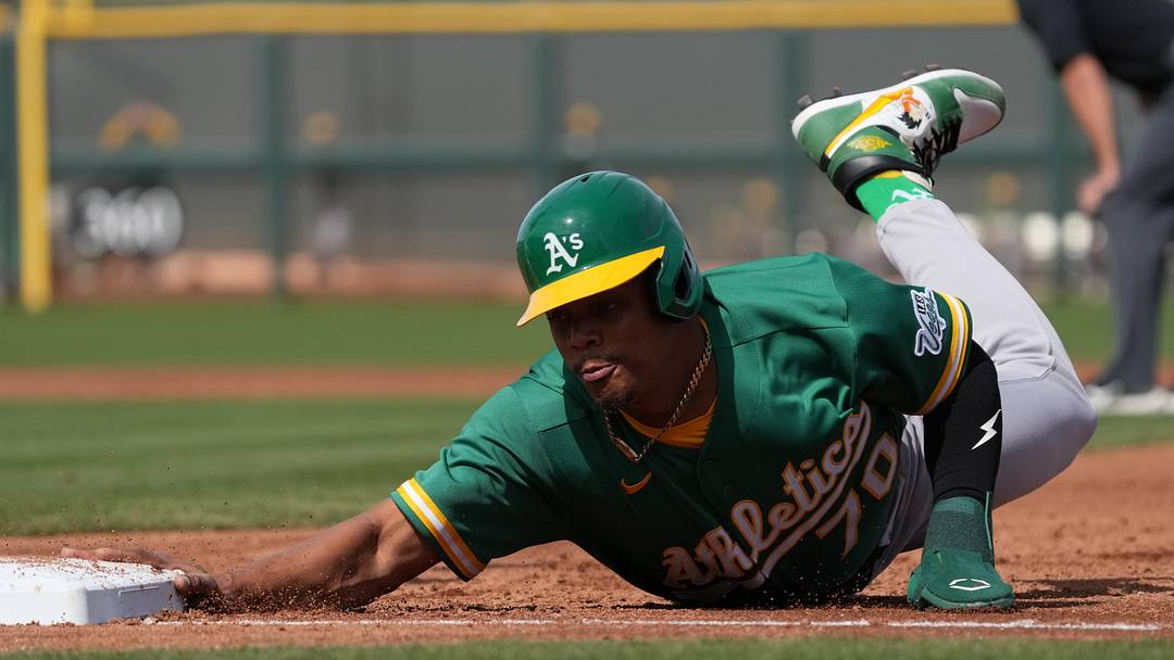 Feb 23, 2026; Scottsdale, Arizona, USA; Athletics center fielder Junior Perez (70) dives back to first against the San Francisco Giants in the first inning at Scottsdale Stadium. Mandatory Credit: Rick Scuteri-Imagn Images Feb 23, 2026; Scottsdale, Arizona, USA; Athletics center fielder Junior Perez (70) dives back to first against the San Francisco Giants in the first inning at Scottsdale Stadium. Mandatory Credit: Rick Scuteri-Imagn Images