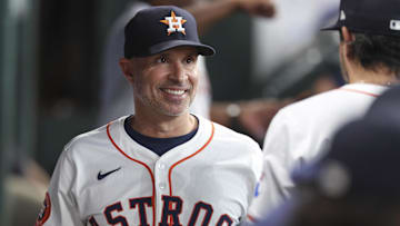 Jun 28, 2025; Houston, Texas, USA; Houston Astros manager Joe Espada (19) smiles in the dugout before the game against the Chicago Cubs at Daikin Park.
