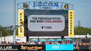 The scoreboard at LECOM Park displays a message about a pitch call being challenged. Major League Baseball is testing an Automated Ball-Stike (ABS) challenge system at select spring training parks. The system allows players to challenge a limited number of ball/stike calls during a game. Calls can be overturned if the pitch tracking technology shows an umpire got a call wrong.
