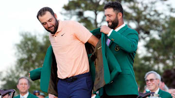 2023 Masters champion Jon Rahm places the green jacket on 2024 Masters champion Scottie Scheffler.