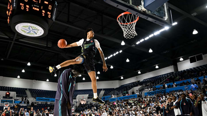 Apr 1, 2024; Houston, TX, USA; McDonalds High School All American guard Jalil Bethea (1) jumps over seven foot two center J.Bol (7) and dunks the ball during the dunk competition in the 2024 McDonalds High School All American Powerade Jam Fest at Delmar Fieldhouse.