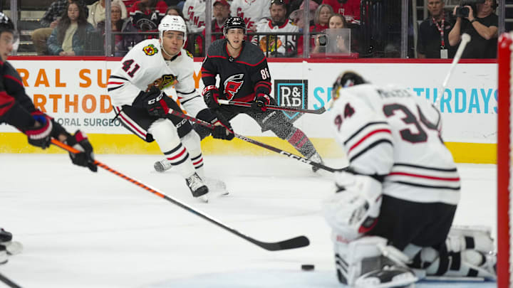 Dec 27, 2022; Raleigh, North Carolina, USA;  Carolina Hurricanes left wing Teuvo Teravainen (86) gets the shot away from Chicago Blackhawks defenseman Isaak Phillips (41) during the first period at PNC Arena. Mandatory Credit: James Guillory-USA TODAY Sports