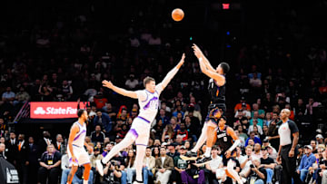 Oct 31, 2025; Phoenix, Arizona, USA; Phoenix Suns guard Devin Booker (1) shoots a three-point shot in the first half between the Phoenix Suns and the Utah Jazz at Mortgage Matchup Center. Mandatory Credit: Arianna Grainey-Imagn Images