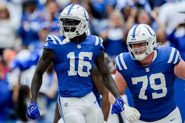 Indianapolis Colts wide receiver Ashton Dulin and left tackle Bernhard Raimann celebrate a touchdown in blue jerseys.