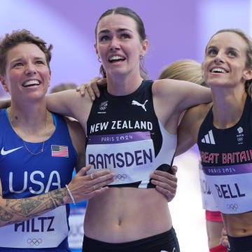 Georgia Bell, right, celebrates advancing in the 1,500 meters