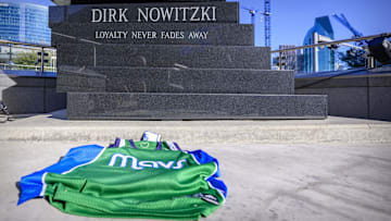 Feb 2, 2025; Dallas, Texas, USA; A Dallas Mavericks fan leave a Mavs jersey at the statue of former player Dirk Nowitzki before the game between the Dallas Stars and the Columbus Blue Jackets at American Airlines Center to protest the trade of Mavericks point guard Luka Doncic to the Los Angeles Lakers. Mandatory Credit: Jerome Miron-Imagn Images